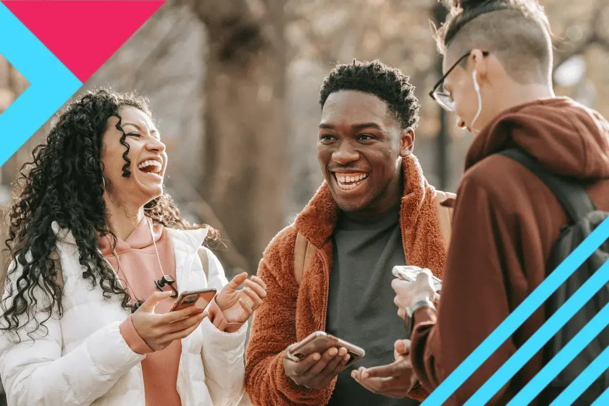 Three friends outdoors laughing while holding smartphones, with trees in the background and colorful geometric shapes overlaying the scene.