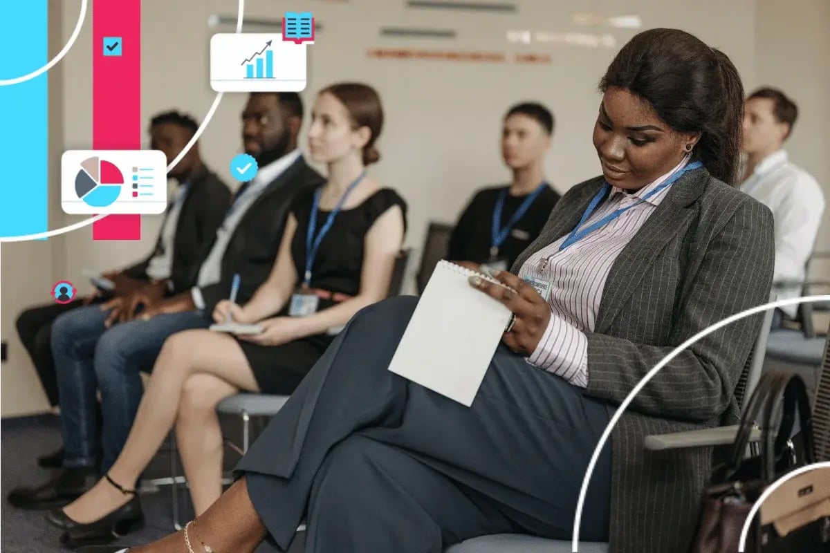 People sit attentively in a seminar room, focusing on a presentation. 